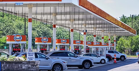 Cars line up at the pumps of a Gulf Oil station on the Massachusetts Turnpike near Boston Sunday, July 19, 2026. 