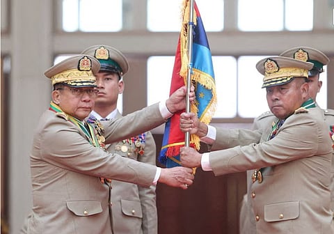 Myanmar junta chief Senior General Min Aung Hlaing hands over a flag to newly appointed Commander-in-Chief General Ye Win Oo during a ceremony in Naypyitaw, Myanmar, March 30, 2026.