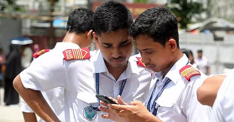 Two SSC candidates from Rajuk Uttara Model College make last-minute preparations before their examination.