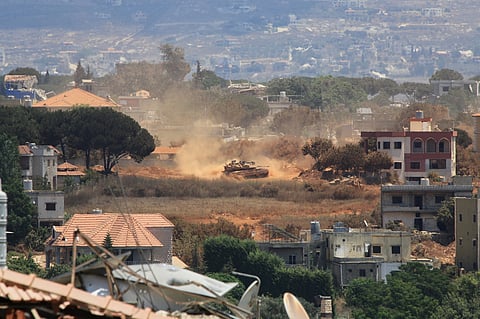 An Israeli tank drives through Zawtar al-Sharqiyah village, occupied by Israeli forces, as seen from the southern village of Zawtar al-Gharbieh, Lebanon, Monday, July 27, 2026.