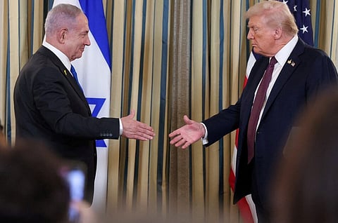 U.S. President Donald Trump and Israeli Prime Minister Benjamin Netanyahu reach to shake hands at a joint press conference in the State Dining Room at the White House in Washington, D.C., U.S., September 29, 2025. 