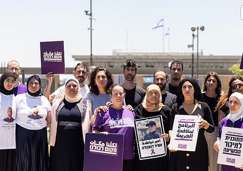 Members of the Standing Together movement, part of a new Arab-Jewish party "A Place For Us All" stand for a photograph with bereaved families of Israel's Arab community, by the Knesset, Israel's Parliament, in Jerusalem, July 13, 2026. 