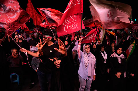 Iranian pro-government demonstrators chant slogans in a gathering at a square in Tehran, Iran, Tuesday, July 28, 2026.