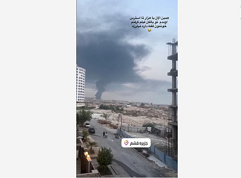 A plume of smoke rises after reported strikes, from Qeshm, Iran, July 30, 2026, in this screengrab obtained from a social media video. 