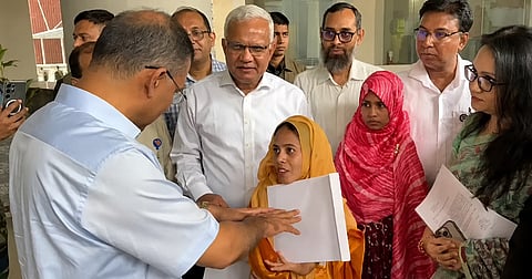 Prime Minister Tarique Rahman hands over a job appointment letter to a woman with disabilities at the Secretariat on July 30, 2026.