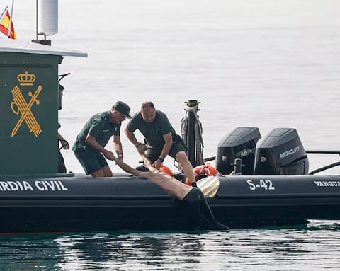 Members of the Spanish Guardia Civil rescue a migrant at sea, after mass crossings of migrants on foot and by sea from Morocco into Spanish territory, in Ceuta, Spain, August 1, 2026. 