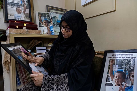 Rokeya Begum with a photograph of Jabir Ibrahim.