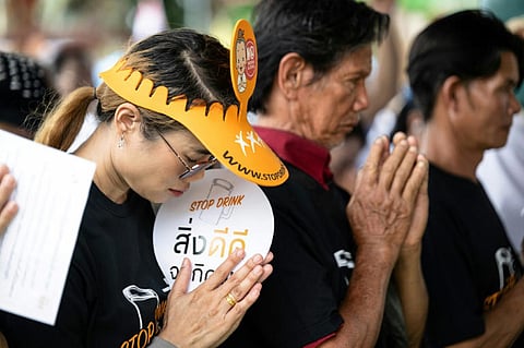 Participants bow in prayer before taking a pledge to avoid alcohol during Khao Phansa, the Buddhist Lent period, at a temple in Samut Sakhon, Thailand.