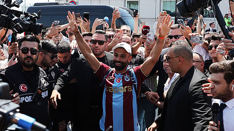 Mohamed Salah waves at fans as he arrives in Turkey to sign with Trabzonspor on Wednesday.