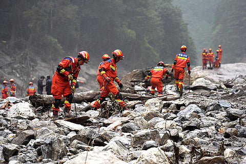 Firefighters conduct search and rescue operations along a river, after a mudslide in Gyirong county, Shigatse, Tibet Autonomous Region, China, August 29, 2026.