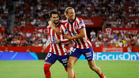 Atletico Madrid's Alex Baena (L) celebrates with Marcos Llorente after scoring their third goal against Sevilla. 