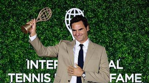 Roger Federer acknowledges from the stage after being inducted into the International Tennis Hall of Fame.
