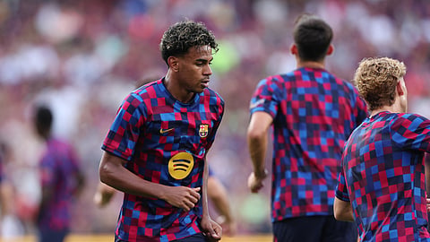 FC Barcelona's Lamine Yamal warms up before the pre-season friendly against Al Ahly.