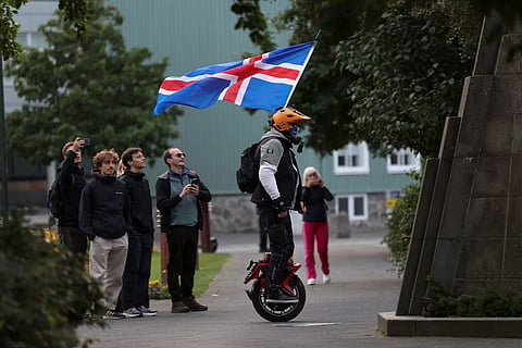  A man with an Icelandic flag rolls around in a park ahead of a referendum on whether Iceland should resume accession negotiations with the European Union, in Reykjavik, Iceland, August 29, 2026.