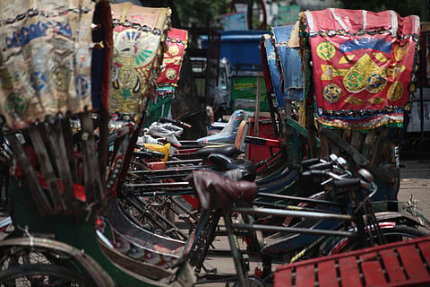 Autorickshaws parked in a city corner