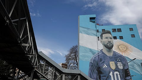 A commuter walks past a mural of Argentine football legend Lionel Messi at Villa del Parque train station in Buenos Aires on August 31, 2026.