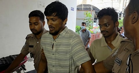 A file photo showing two of the accused being taken away by police.