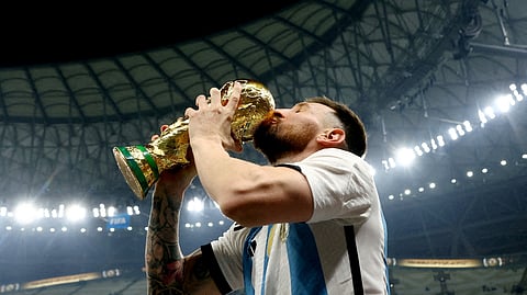 Lionel Messi kisses the World Cup trophy after Argentina beat France in the final of the 2022 FIFA World Cup in Doha, Qatar.