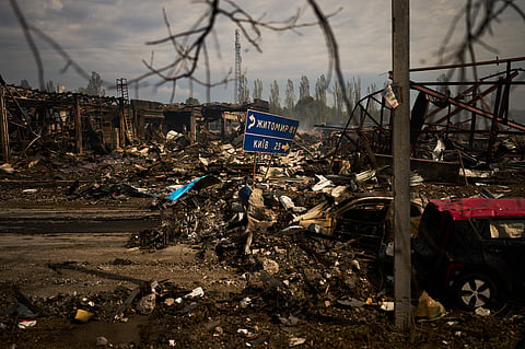 Destroyed vehicles and debris are scattered the day after a Russian attack struck a warehouse, followed by an explosion, in the village of Myla, outskirts of Kyiv, Sunday, Aug 30, 2026