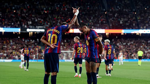 Lamine Yamal (L) celebrates with Raphinha after scoring Barcelona’s second goal against Rayo Vallecano. 