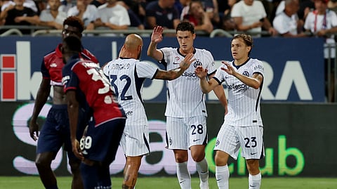 Inter Milan's Benjamin Pavard, Nicolo Barella and Federico Dimarco celebrate after the match.