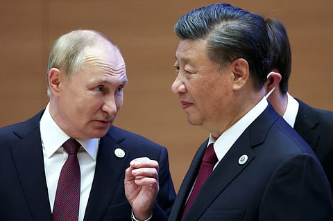 Russian President Vladimir Putin, left, gestures while speaking to Chinese President Xi Jinping during the Shanghai Cooperation Organization (SCO) summit in Samarkand, Uzbekistan, Sept 16, 2022.