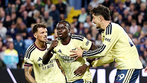 Arsenal's Bukayo Saka celebrates with Ben White (L) and Kai Havertz (R) after scoring the winning goal against Aston Villa. 