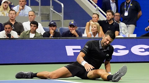 Serbia's Novak Djokovic lies on the court during his first round match against Argentina's Mariano Navone.