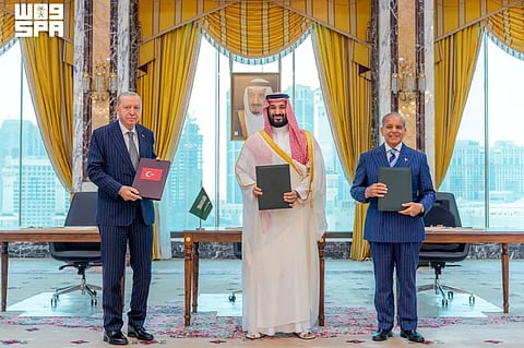 Turkish President Recep Tayyip Erdogan, Saudi Crown Prince Mohammed bin Salman, and Pakistan's Prime Minister Shehbaz Sharif pose after signing a joint defence agreement in Mecca, Saudi Arabia, August 7, 2026.