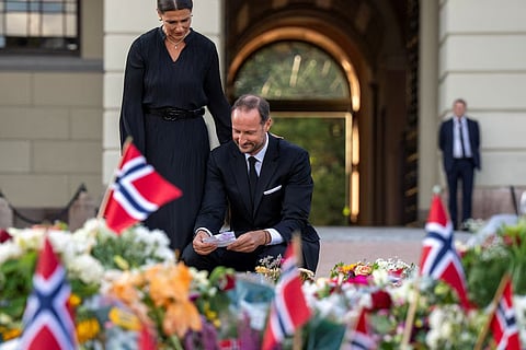 King Haakon and Princess Martha Louise at the Palace Square where they each laid a rose in the sea of flowers after the death of King Harald V.