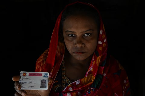 Chinu Bala, the wife of Milton Shil shows her Husband’s refugee card. Shil died a few months ago