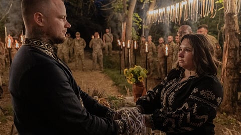Ukrainian soldiers Ice and Khomochka exchange wedding vows during a Slavic ritual near the eastern front.