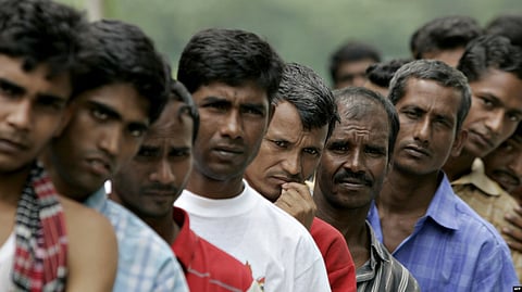 Bangladeshi migrant workers wait in line for food donated by a goodwill charity group for Christmas outside the Bangladeshi High Commission in Kuala Lumpur, Malaysia, Dec 25, 2007. 