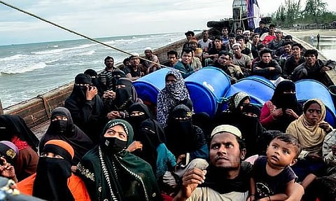 In this photo taken on January 29, 2025, Rohingya refugees remain aboard their boat at Leuge Beach in Indonesia's Aceh province after authorities prevented them from disembarking. 