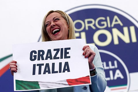 Leader of Brothers of Italy Giorgia Meloni holds a sign at the party's election night headquarters, in Rome, Italy September 26, 2022