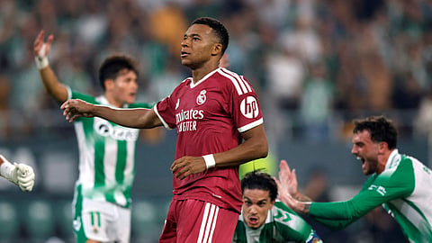 Real Madrid's Kylian Mbappe looks dejected after his penalty is saved by Real Betis' Alvaro Valles.