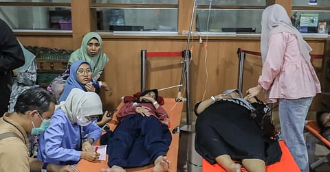 Students who allegedly fell ill from  food poisoning after eating free meals at their school receive treatment at a hospital in Sidoarjo, East Java, Indonesia, on Wednesday, Sept. 2, 2026. 