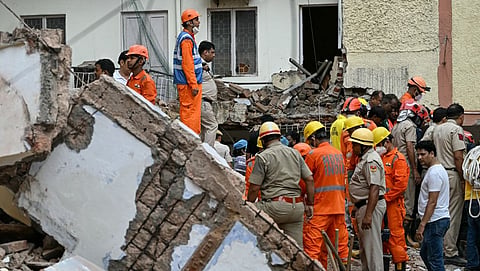 Rescue personnel conduct a search operation for survivors at the site of a building collapse in the Satya Niketan area in New Delhi on September 6, 2026.