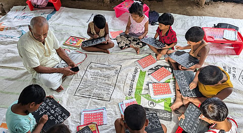 Ramani Kanta with his pupils inside a temple courtyard 
