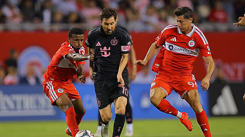 Inter Miami's Lionel Messi controls the ball against  Chicago Fire's Robert Lewandowski (R) during the first half at Soldier Field in Chicago, Illinois.