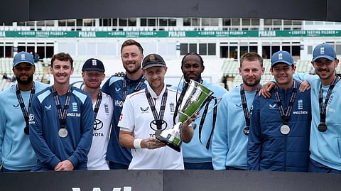 England's Joe Root celebrates winning the series with the trophy and teammates.