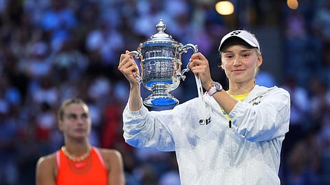 Kazakhstan's Elena Rybakina celebrates with the winner's trophy after her final match against Belarus' Aryna Sabalenka.
