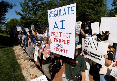 A demonstrator holds a sign calling for regulation of artificial intelligence during a protest outside the G20 Innovation Ministerial summit, in Chapel Hill, North Carolina, U.S., September 2, 2026. 