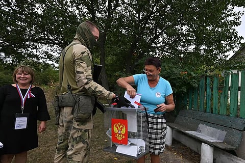 A voter casts a ballot during Russia’s tightly controlled parliamentary elections.
