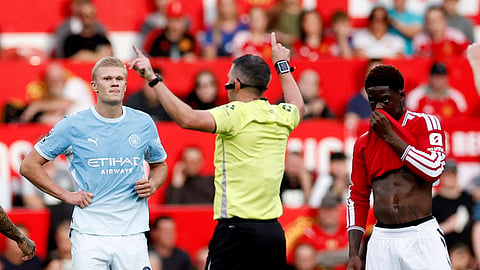 Manchester City's Erling Haaland reacts as referee Michael Oliver awards the goal following a VAR review.