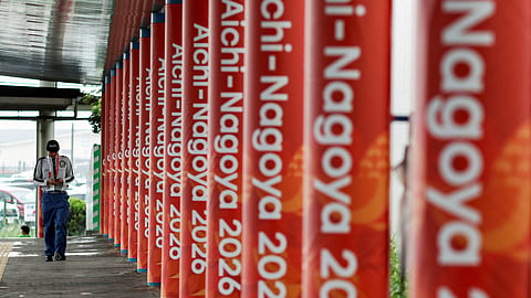 A security officer passes Asian Games signages outside the main media center in Nagoya, Japan, September 14, 2026.