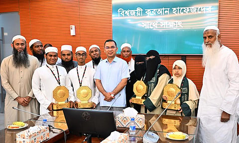 Prime Minister Tarique Rahman poses with Bangladeshi hafiz who won prizes at the 46th King Abdulaziz International Holy Quran Competition in Saudi Arabia during a reception at the Bangladesh Secretariat on Thursday.