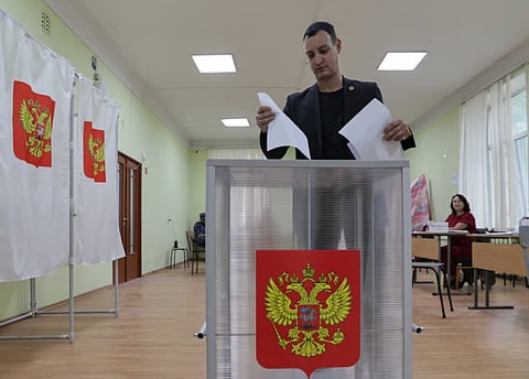 A voter casts his ballot at a polling station on the final day of Russia's parliamentary election in Vladivostok, Russia, September 20, 2026.