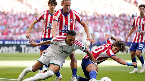 Real Madrid's Kylian Mbappe in action with Atletico Madrid's Giuliano Simeone and Marcos Llorente.