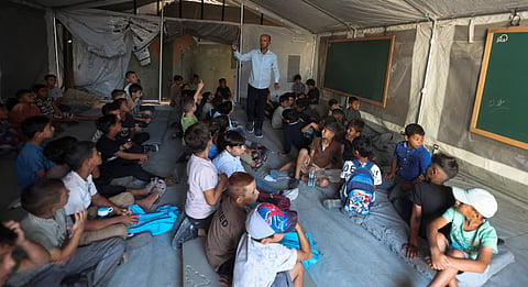 Palestinian students attend their first day of the new school year inside a tent classroom at a school in Khan Younis, in the southern Gaza Strip, September 19, 2026.